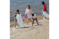 Image A family collecting trash on a beach.